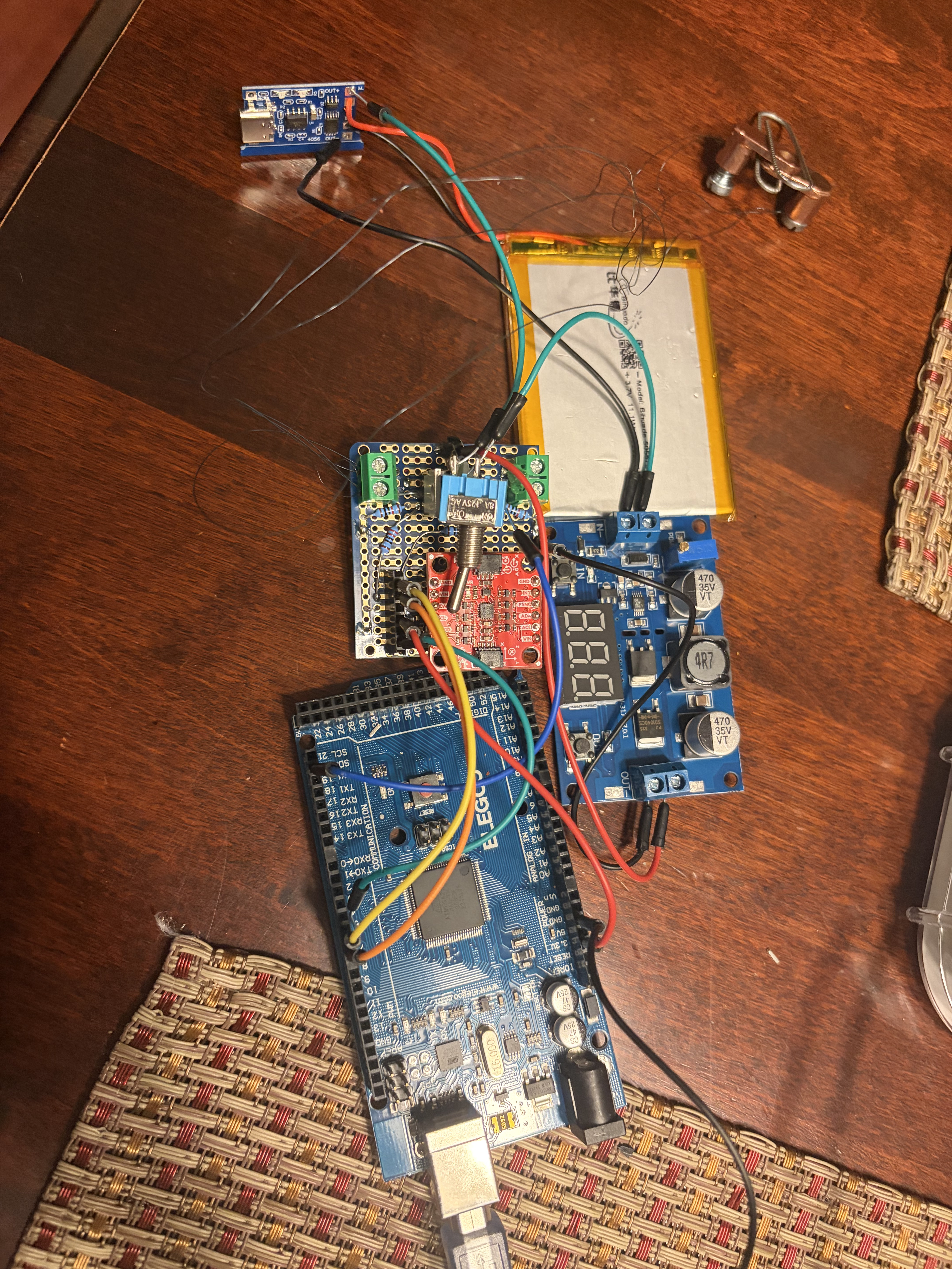 Posture Pro prototype electronics including microcontroller, battery, power electronics, and IMU